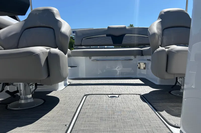 Slide: The Image of 2025 Four Winns HD3 boat interior with gray seating and carpeted flooring. - 14