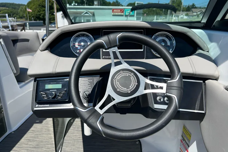 Slide: The Image of 2025 Four Winns HD3 boat dashboard with steering wheel and instrument panel. - 17