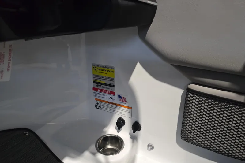 Slide: The Image of Interior of 2025 Four Winns HD3 boat showing capacity and safety labels. - 19