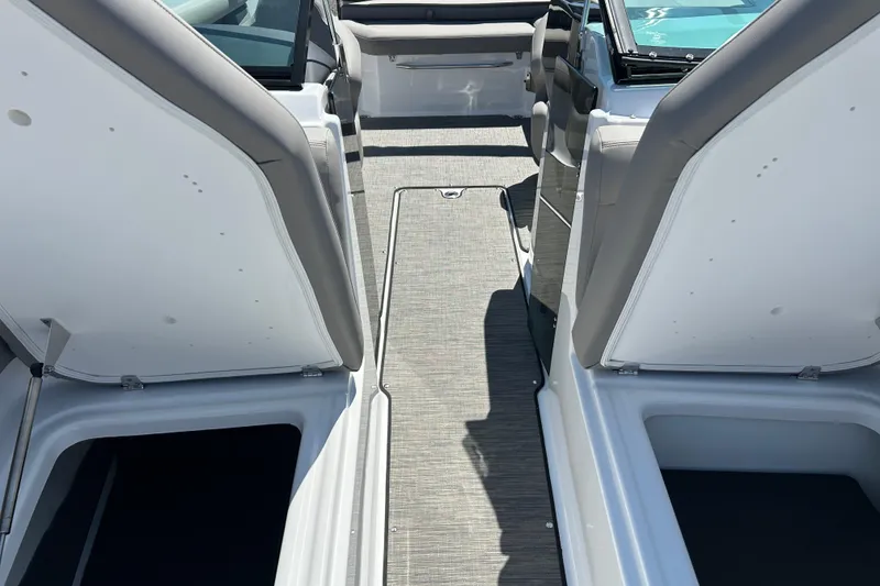 Slide: The Image of 2025 Four Winns HD3 boat interior with open storage compartments and seating. - 28