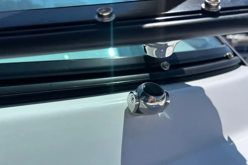 Slide: The Image of Close-up of 2025 Four Winns HD3 boat hardware and windshield detail. - 34