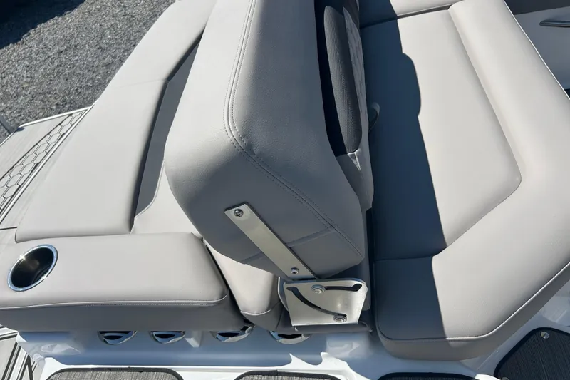Slide: The Image of 2025 Four Winns HD3 boat seating with cup holder, featuring sleek gray upholstery. - 36
