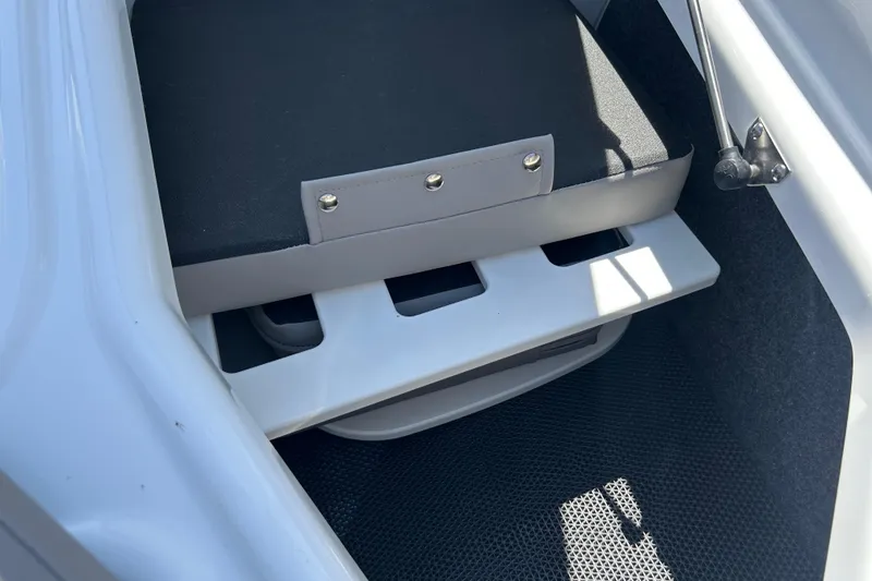 Slide: The Image of 2025 Four Winns HD3 boat interior storage compartment with cushioned seating. - 44