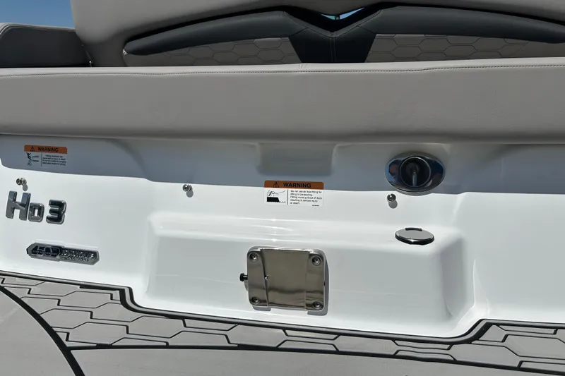 Slide: The Image of 2025 Four Winns HD3 boat rear view with warning labels and seating details. - 45