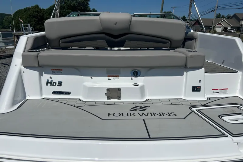 Slide: The Image of 2025 Four Winns HD3 boat rear view with seating and logo on deck. - 9