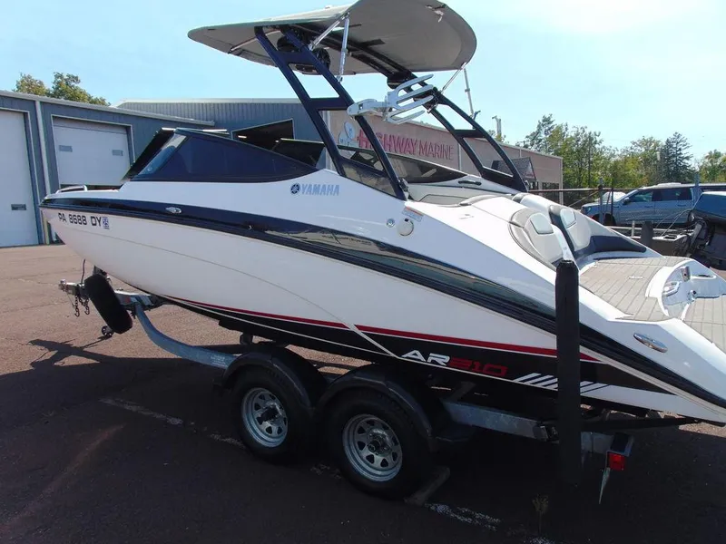 Slide: The Image of 2017 Yamaha AR210 boat on trailer, parked outdoors near storage facility. - 5