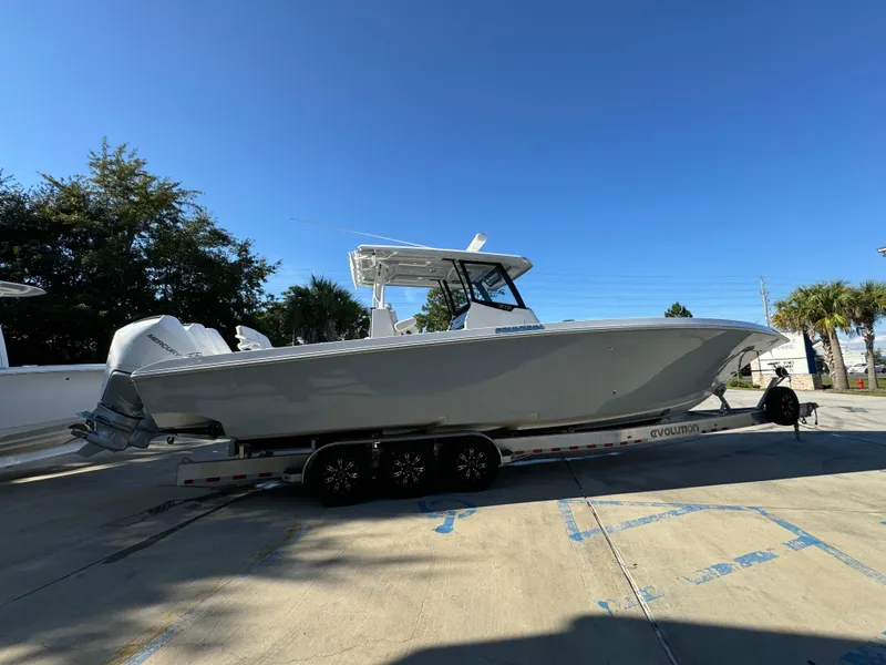 Slide: The Image of 2025 Fountain 38TE boat on trailer under clear blue sky. - 11