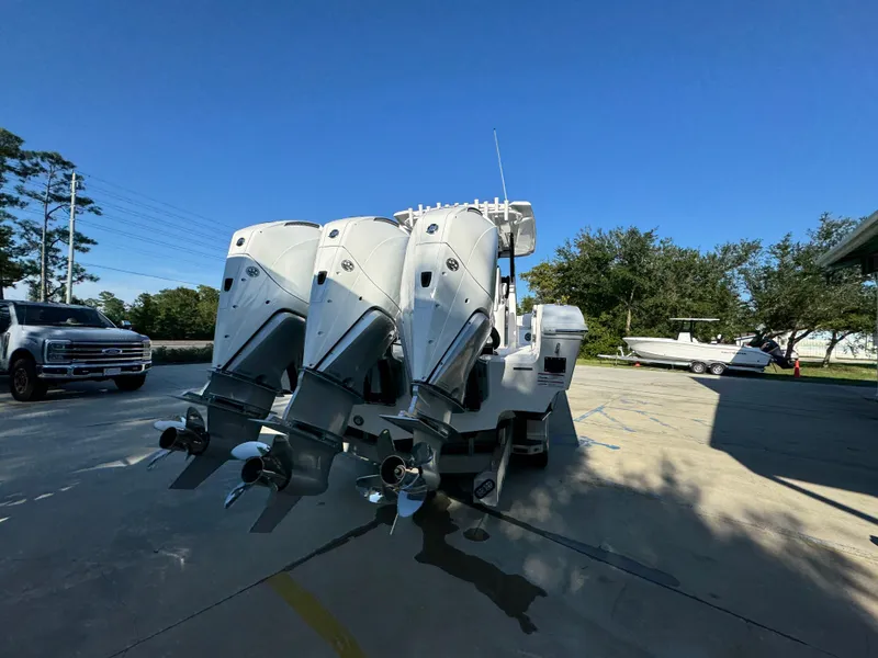 Slide: The Image of 2025 Fountain 38TE boat with triple outboard engines in a sunny outdoor setting. - 15