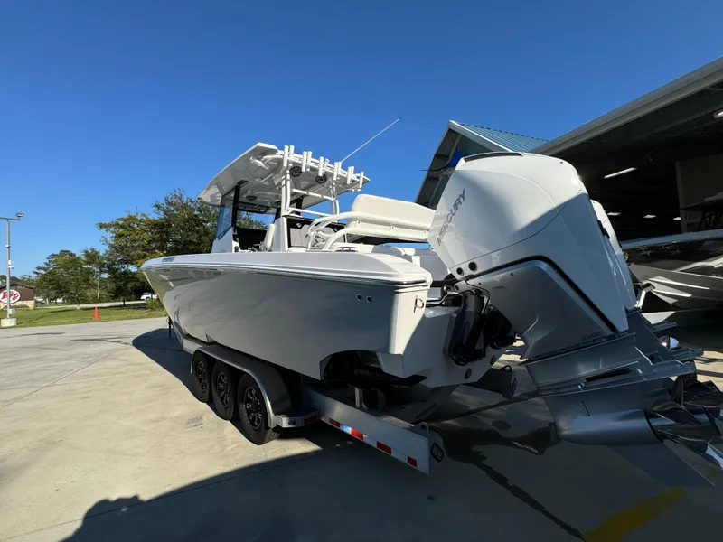 Slide: The Image of 2025 Fountain 38TE boat on trailer, parked outdoors under clear blue sky. - 18