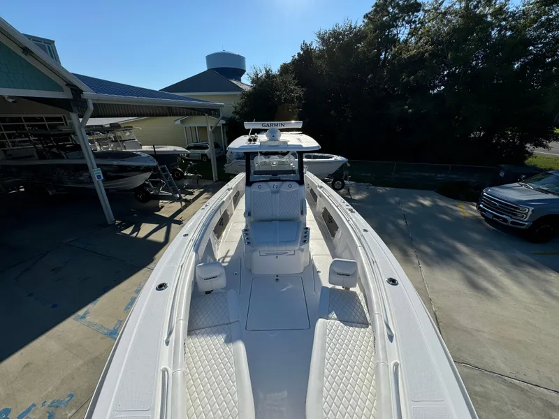 Slide: The Image of 2025 Fountain 38TE boat docked, showcasing sleek design and spacious deck. - 22