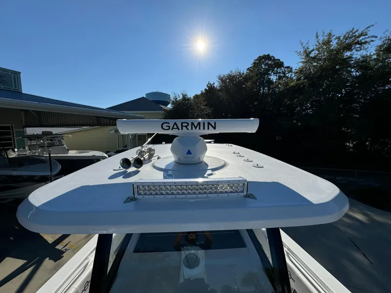 Slide: The Image of 2025 Fountain 38TE boat with Garmin radar under a clear blue sky. - 24