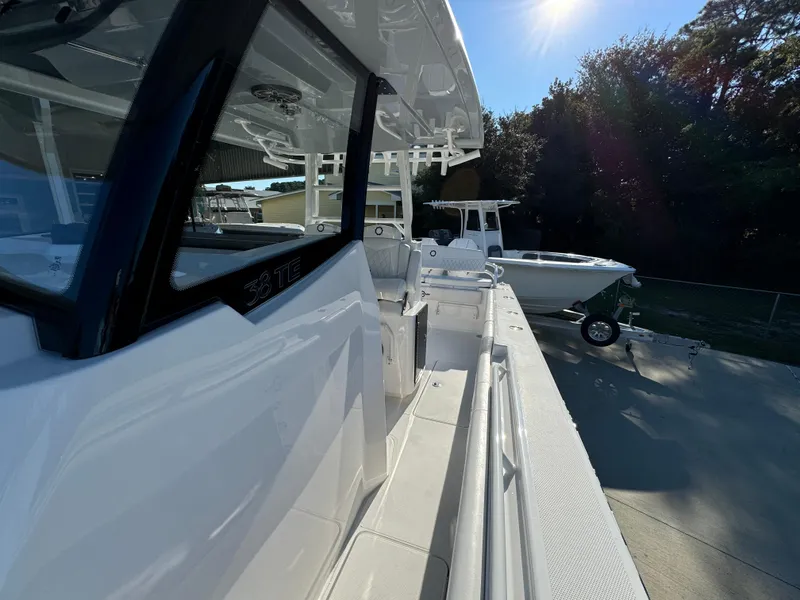 Slide: The Image of 2025 Fountain 38TE boat docked under sunlight, showcasing sleek design and modern features. - 25