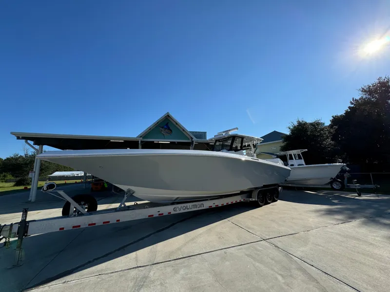 Slide: The Image of 2025 Fountain 38TE boat on trailer under clear blue sky. - 3