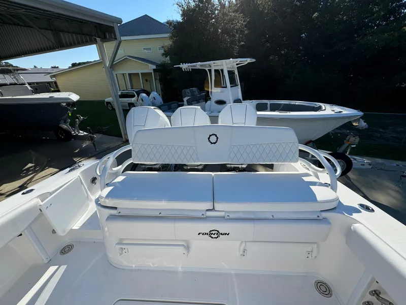 Slide: The Image of 2025 Fountain 38TE boat with white seating, docked outdoors. - 34