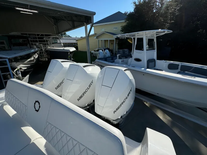 Slide: The Image of 2025 Fountain 38TE boat with triple Mercury outboard engines in a marina setting. - 35
