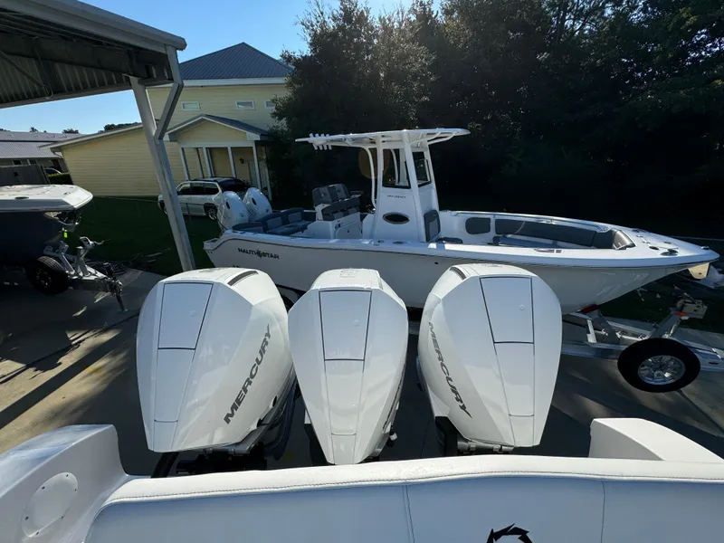 Slide: The Image of 2025 Fountain 38TE boat with triple Mercury engines, parked outdoors. - 36