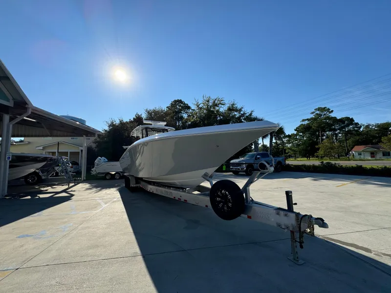 Slide: The Image of 2025 Fountain 38TE boat on trailer under clear blue sky. - 7