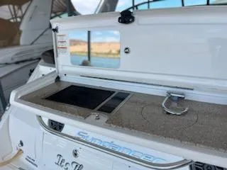 Slide: The Image of 2016 Sea Ray 350 Sundancer boat with open deck storage and scenic view. - 11