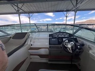 Slide: The Image of 2016 Sea Ray 350 Sundancer helm with modern controls and panoramic view. - 14