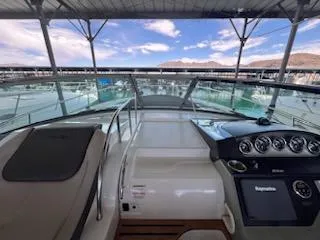 Slide: The Image of 2016 Sea Ray 350 Sundancer helm with marina view, under covered dock. - 15