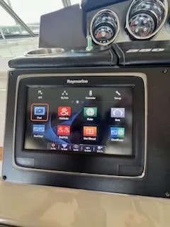 Slide: The Image of 2016 Sea Ray 350 Sundancer dashboard with Raymarine navigation display. - 19