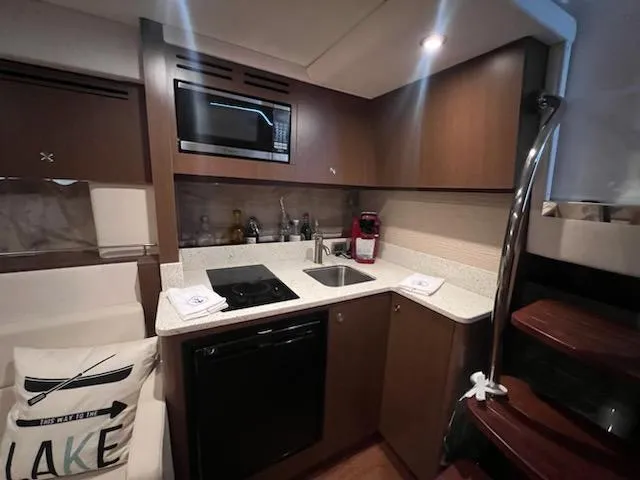Slide: The Image of Modern kitchen in 2016 Sea Ray 350 Sundancer yacht with microwave and sink. - 21