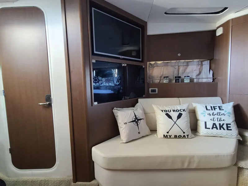 Slide: The Image of Interior of 2016 Sea Ray 350 Sundancer with cozy seating and decorative pillows. - 23