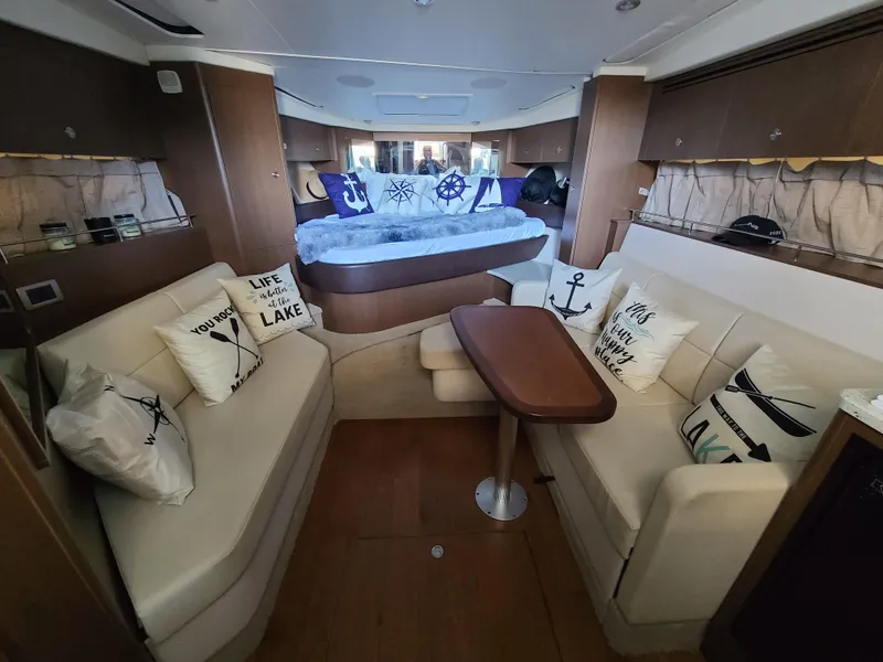 Slide: The Image of Interior of 2016 Sea Ray 350 Sundancer yacht with cozy seating and nautical decor. - 27