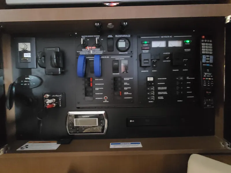 Slide: The Image of Control panel of a 2016 Sea Ray 350 Sundancer boat, featuring various switches and gauges. - 31