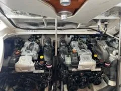 Slide: The Image of Engine compartment of 2016 Sea Ray 350 Sundancer boat, showcasing dual engines. - 34