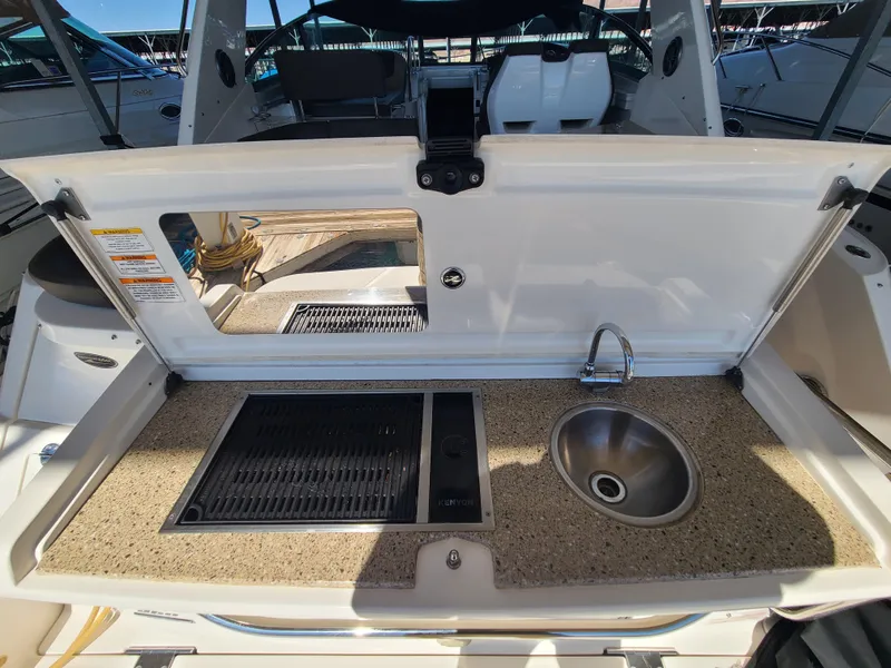 Slide: The Image of 2016 Sea Ray 350 Sundancer boat kitchenette with sink and grill. - 36