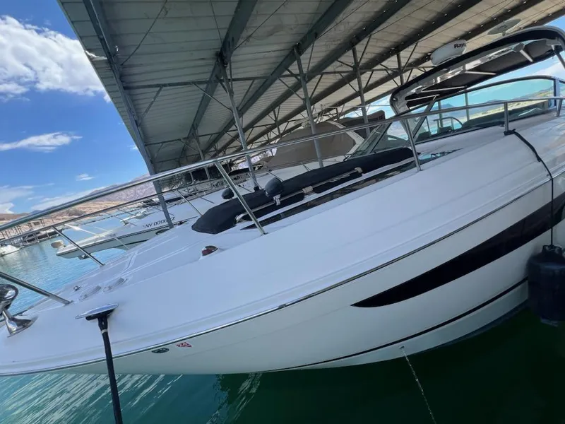 Slide: The Image of 2016 Sea Ray 350 Sundancer docked under a marina roof. - 6