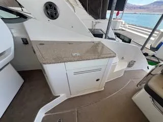 Slide: The Image of 2016 Sea Ray 350 Sundancer yacht interior with kitchenette and lake view. - 9