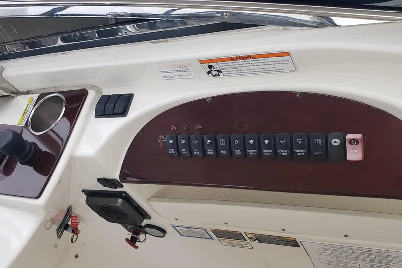 Slide: The Image of Control panel of a 2010 Meridian 441 Sedan yacht with labeled switches and warning labels. - 10