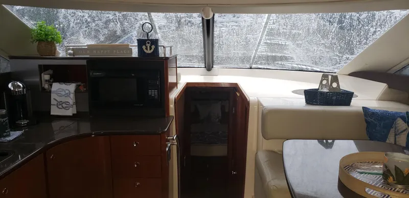 Slide: The Image of Interior of 2010 Meridian 441 Sedan yacht with kitchen and seating area. - 14