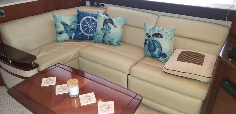 Slide: The Image of Luxurious Meridian 441 Sedan 2010 interior with beige leather seating and nautical-themed pillows. - 17