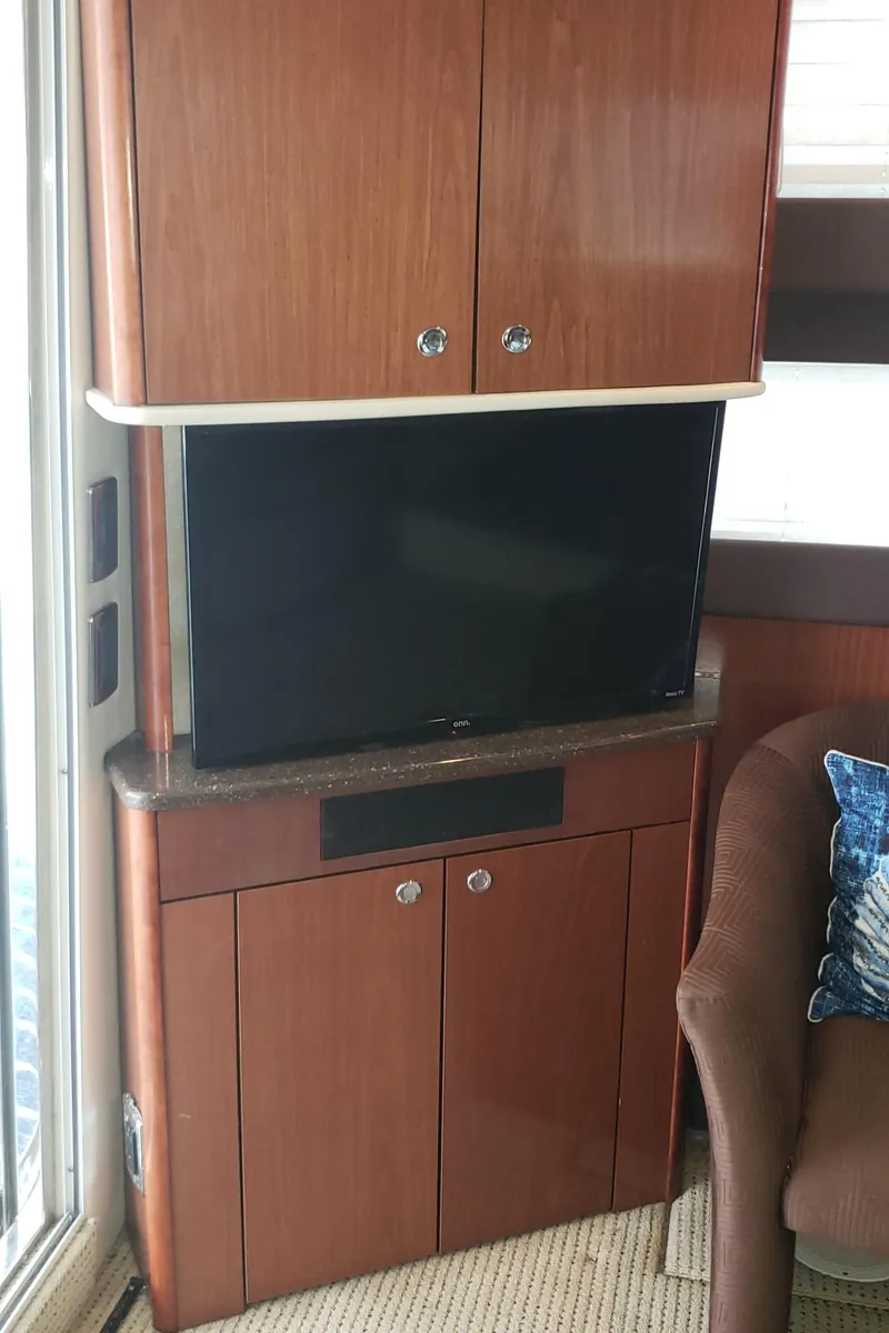 Slide: The Image of 2010 Meridian 441 Sedan interior with TV and wooden cabinetry. - 22