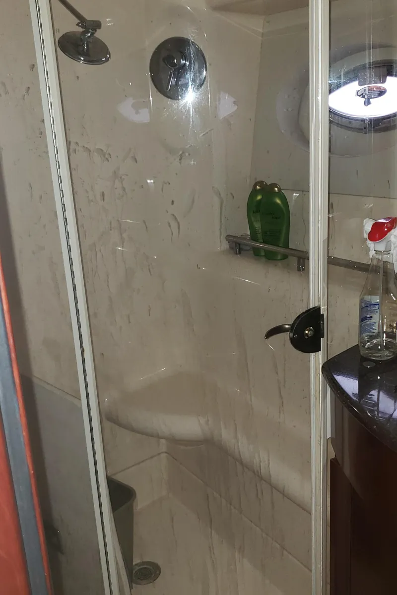 Slide: The Image of Shower area in 2010 Meridian 441 Sedan yacht with glass door and porthole. - 23