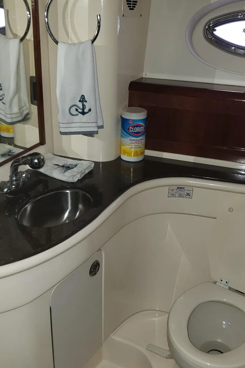 Slide: The Image of 2010 Meridian 441 Sedan yacht bathroom with sink, toilet, and cleaning supplies. - 26