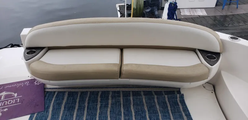 Slide: The Image of 2010 Meridian 441 Sedan boat seating with striped rug and cup holders. - 7
