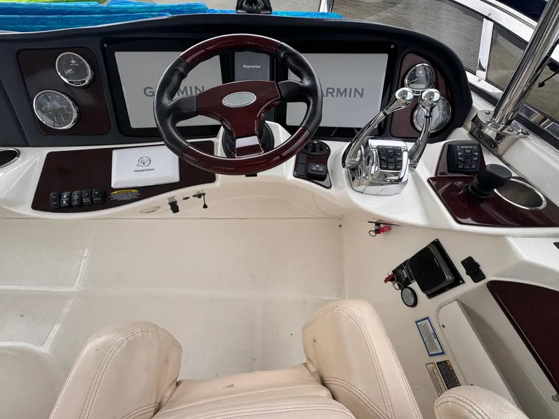 Slide: The Image of 2010 Meridian 441 Sedan helm with Garmin navigation, steering wheel, and control panel. - 9