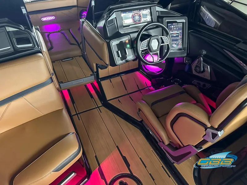 Slide: The Image of 2024 Supra SE interior with modern dashboard, brown seats, and ambient pink lighting. - 16