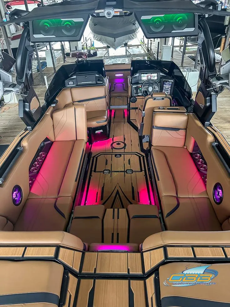 Slide: The Image of 2024 Supra SE boat interior with luxurious seating and vibrant LED lighting. - 18