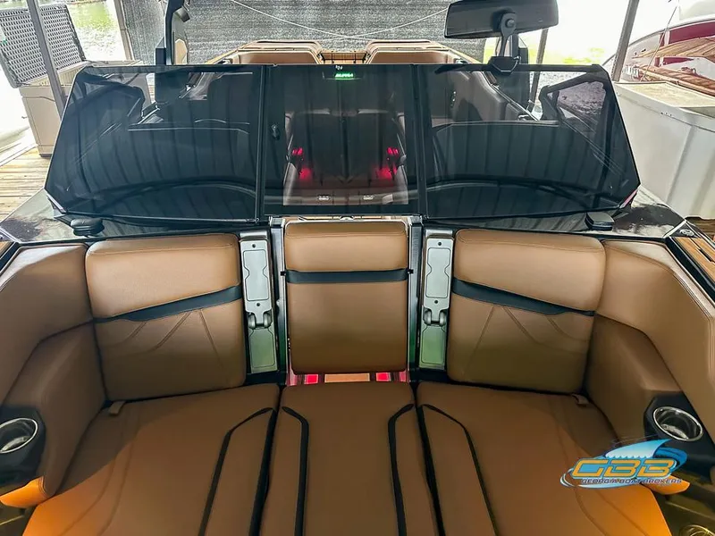 Slide: The Image of 2024 Supra SE boat interior with brown leather seats and sleek design. - 21