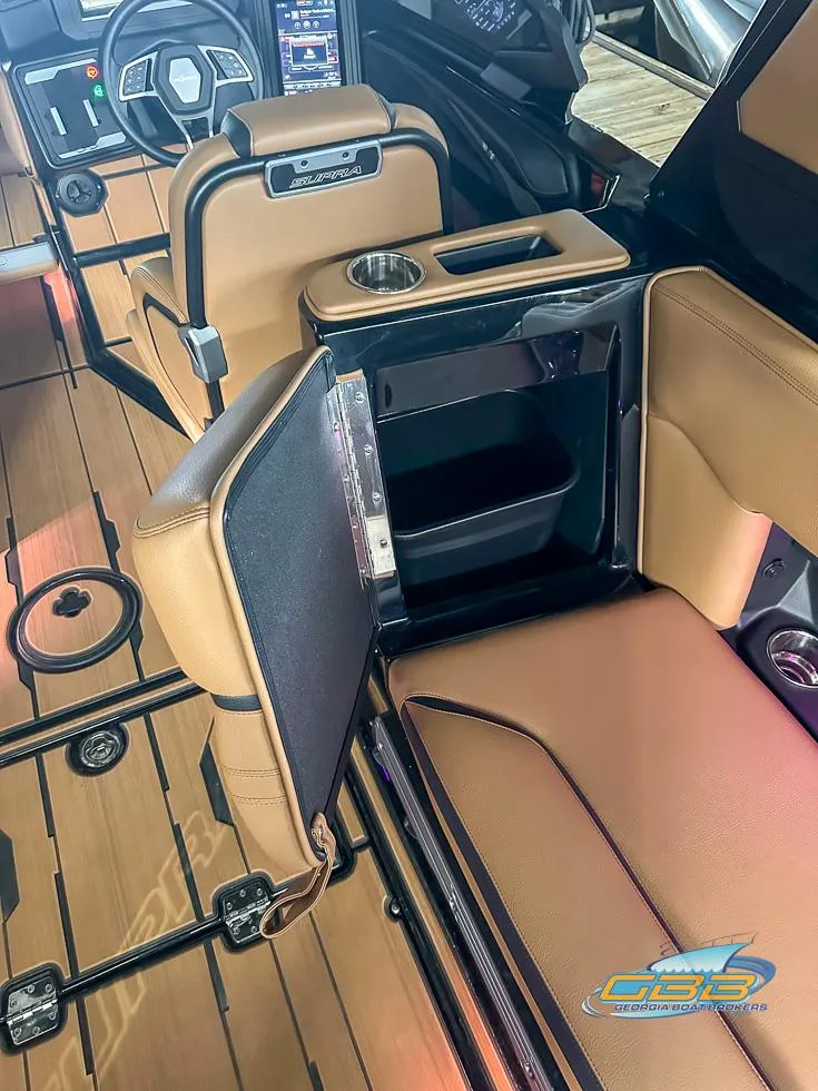 Slide: The Image of 2024 Supra SE interior with tan leather seats and storage compartment. - 23