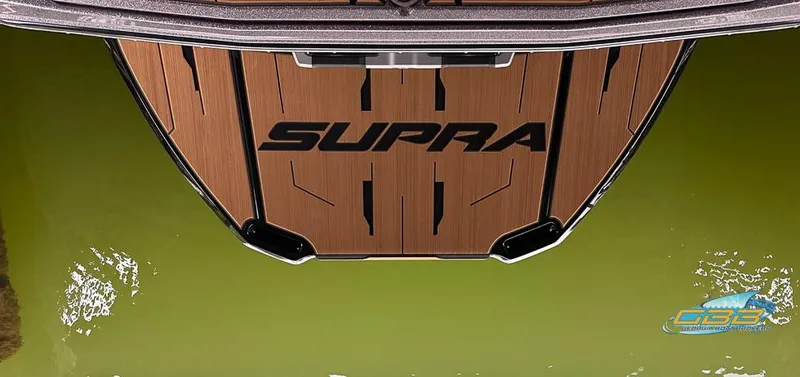Slide: The Image of 2024 Supra SE boat deck with wood finish on green water. - 28