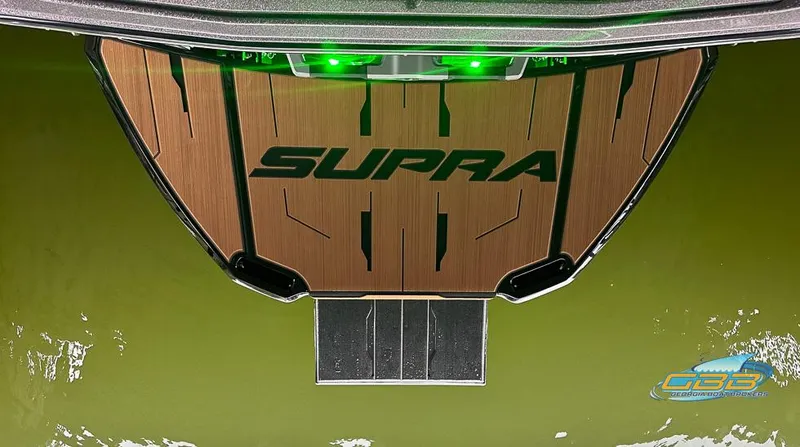 Slide: The Image of 2024 Supra SE boat platform with green lights on water. - 29