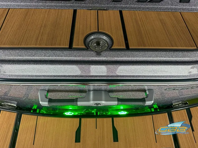 Slide: The Image of 2024 Supra SE boat with wooden deck and green LED lights. - 31