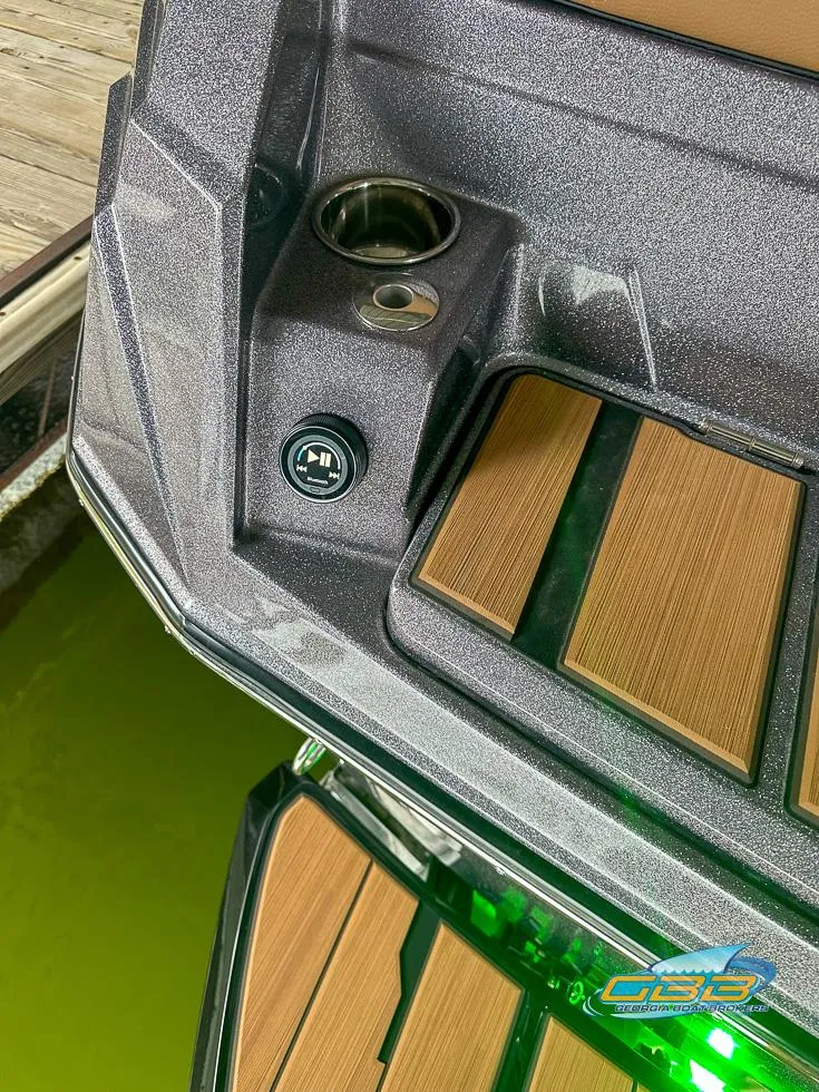 Slide: The Image of 2024 Supra SE boat deck with cup holder and wood accents. - 32