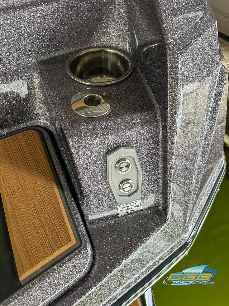 Slide: The Image of 2024 Supra SE boat detail with cup holder and control buttons. - 33